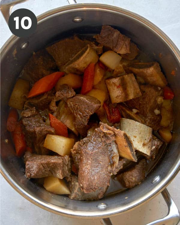 Short ribs in a pot with vegetables cooking to make Galbi Jjim. 