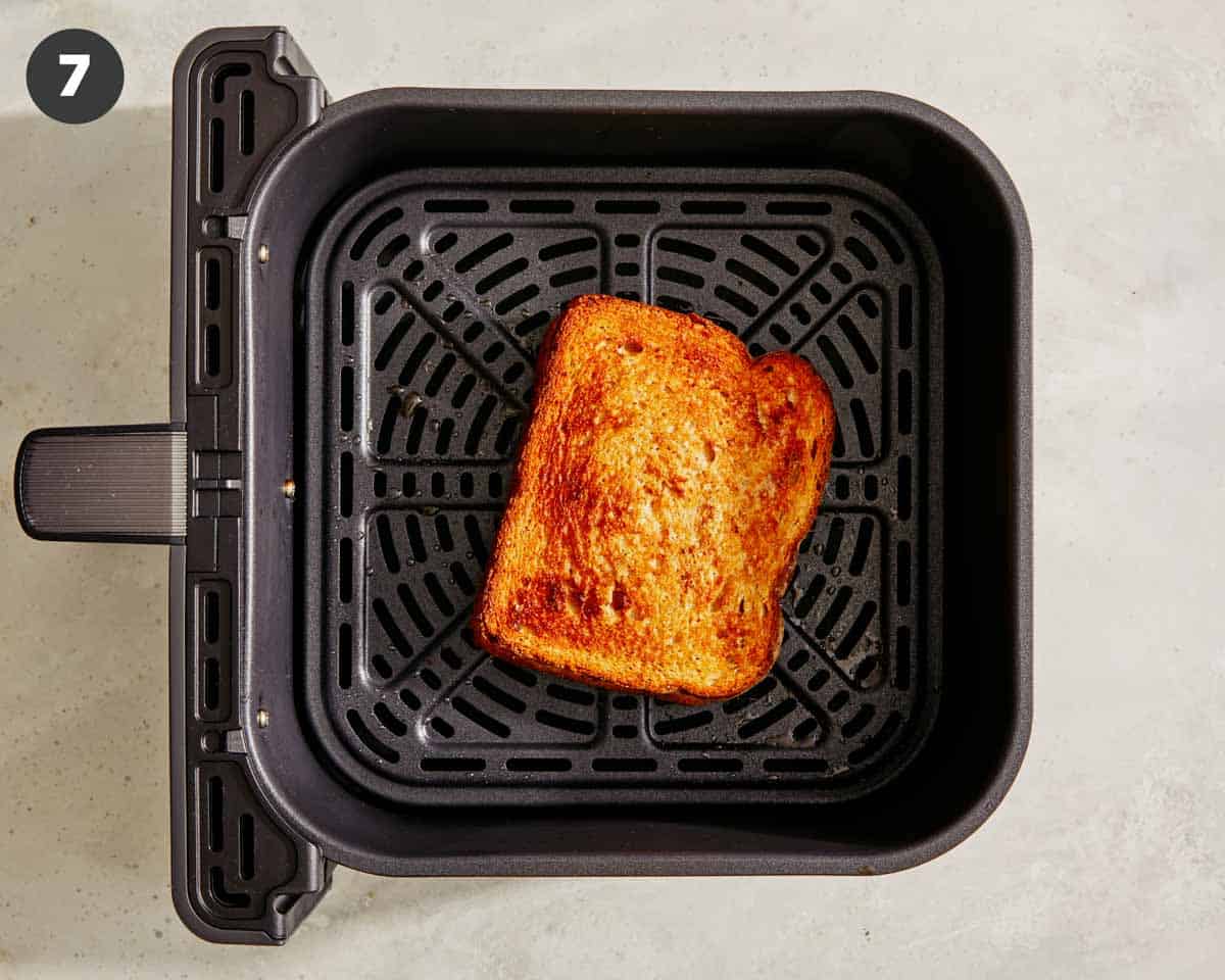 Tuna melt in an air fryer being cooked. 