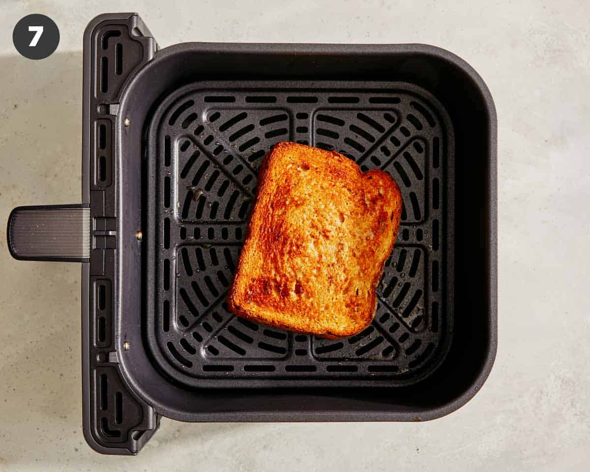 Tuna melt in an air fryer being cooked.
