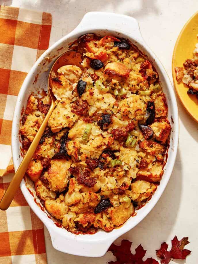 Sausage stuffing recipe in a casserole dish with a scoop out.