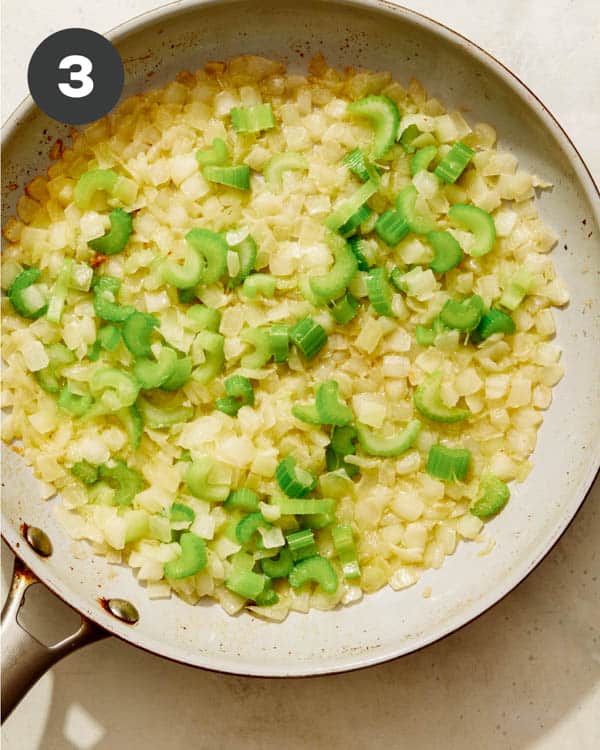 Onions and celery cooking in a skillet for stuffing. 