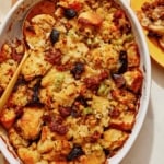 Sausage stuffing recipe in a casserole dish with a scoop out.