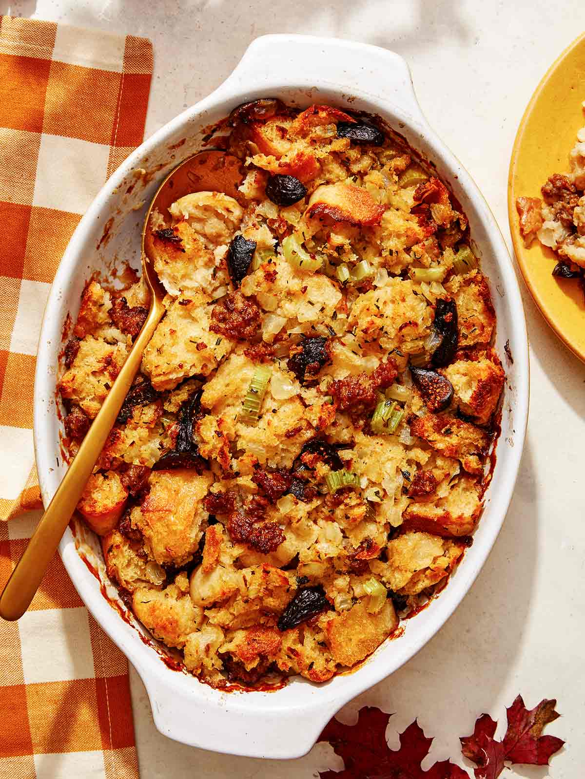 Sausage stuffing recipe in a casserole dish with a scoop out. 