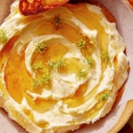 Whipped brie recipe in a bowl with honey.