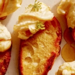 Whipped brie smeared on a crostini.