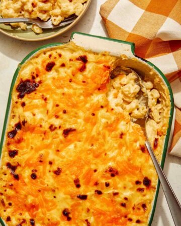 Baked mac and cheese recipe with a scoop out of it.