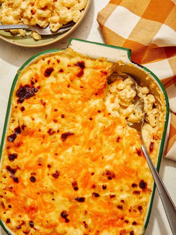 Baked mac and cheese recipe with a scoop out of it.