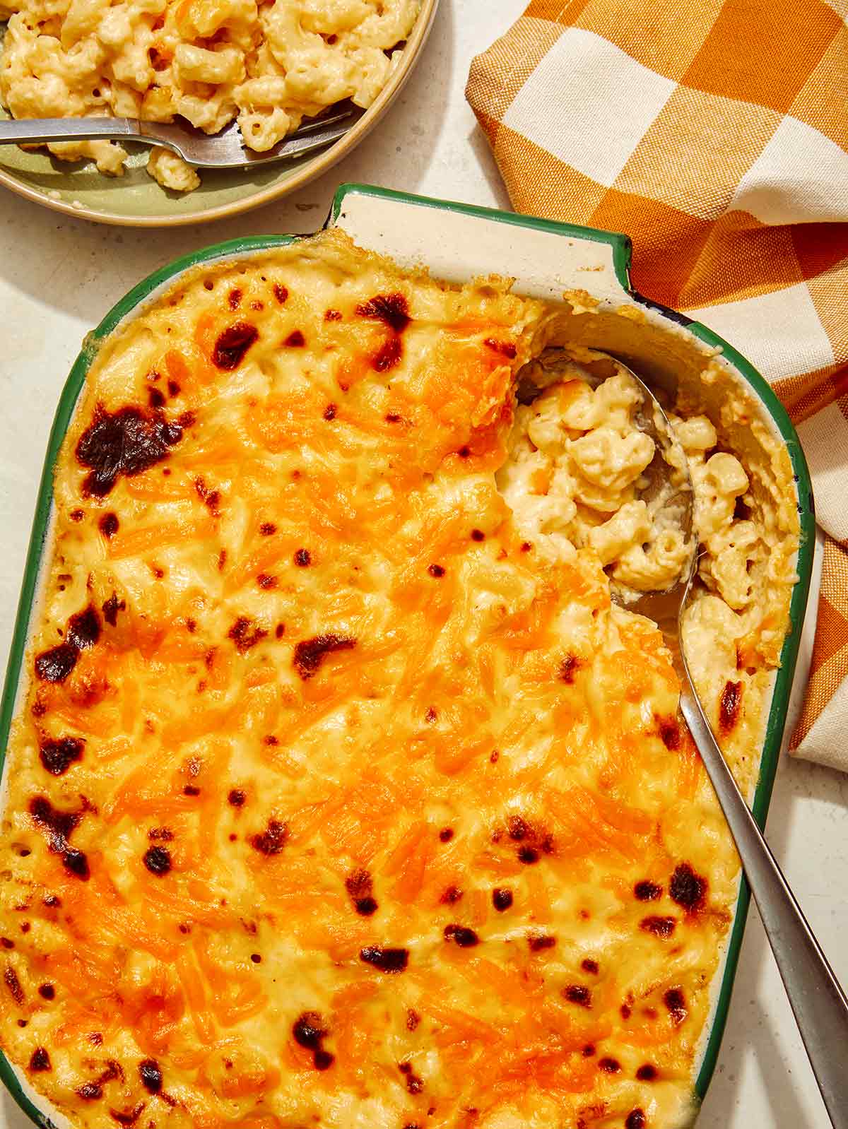 Baked mac and cheese recipe with a scoop out of it. 