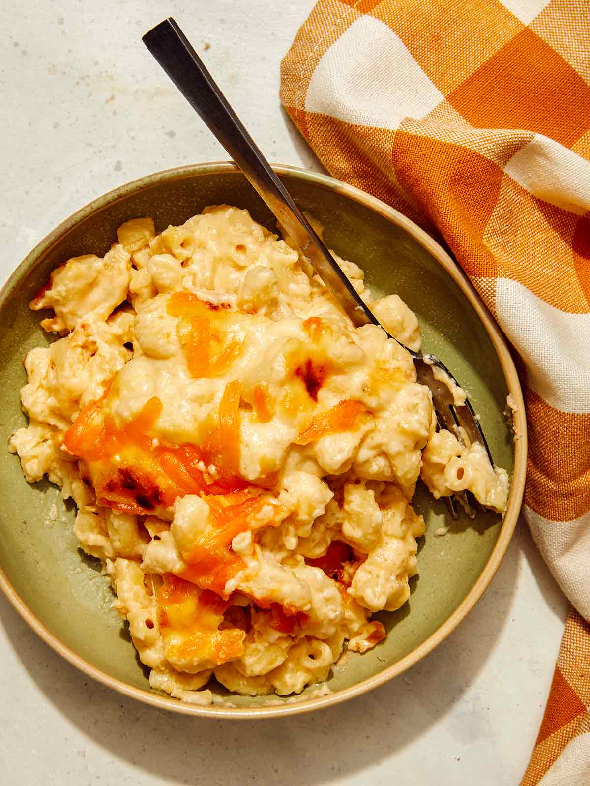 Baked mac and cheese scooped out into a bowl. 