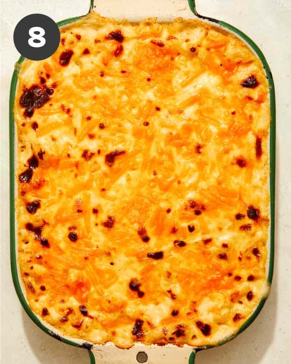 Mac and cheese being baked in a casserole dish. 