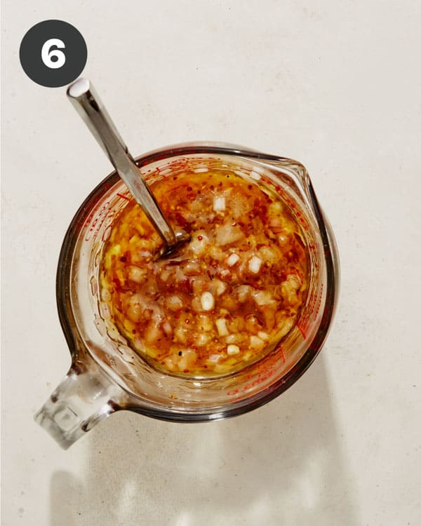 Vinaigrette dressing mixed in a measuring cup. 