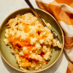 Baked mac and cheese scooped out into a bowl.