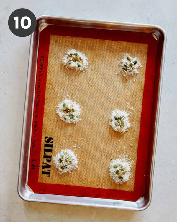 Parmesan and seeds on a baking sheet to make Parmesan Crisps.