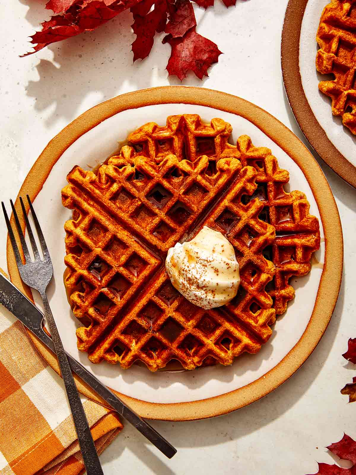 Pumpkin waffle recipe on a plate being served.