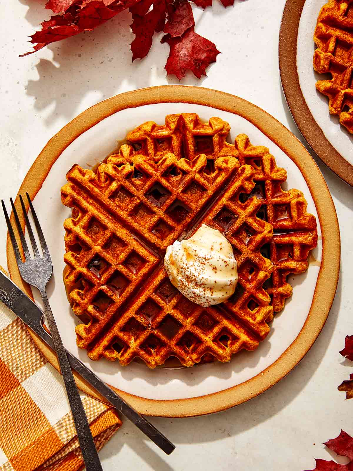 Pumpkin waffle recipe on a plate being served. 