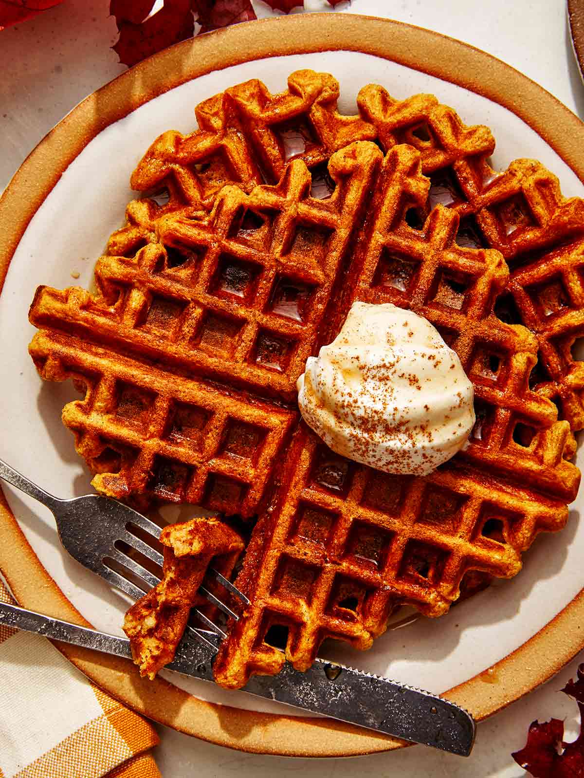 Pumpkin waffles with a bite taken out of them.