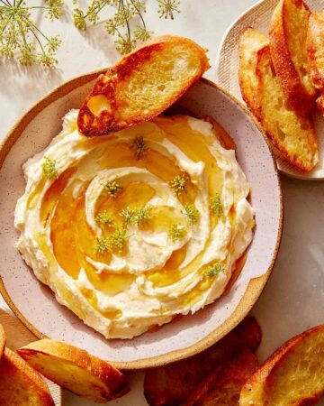 Whipped brie recipe in a bowl with honey.