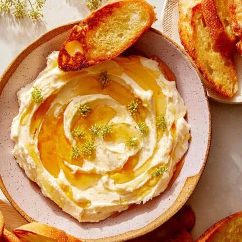 Whipped brie recipe in a bowl with honey.