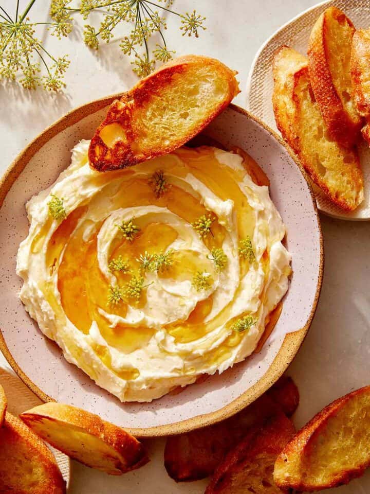 Whipped brie recipe in a bowl with honey.