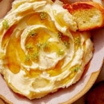 Whipped brie in a bowl with crostini.