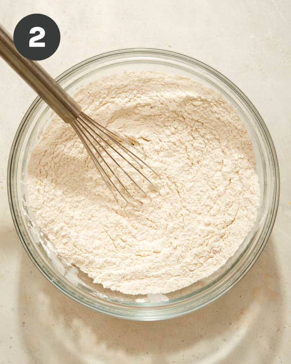 Flour in a bowl being whisked together. 