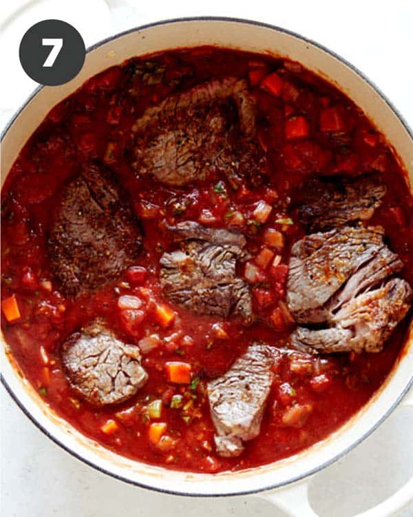 Beef in tomato sauce in a stock pot.