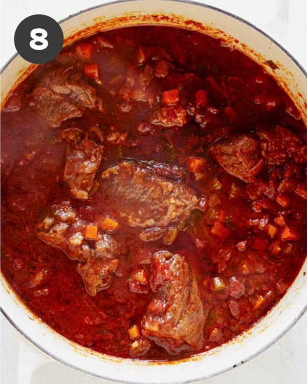 Beef simmering in a stock pot to make beef ragu.