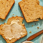 Beer bread on a plate with butter on the slices.