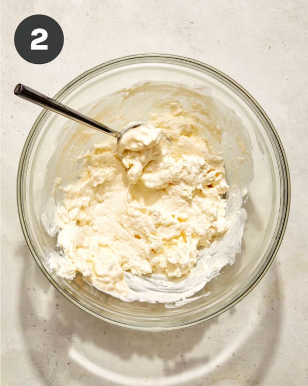 Corn dip base in a glass bowl.