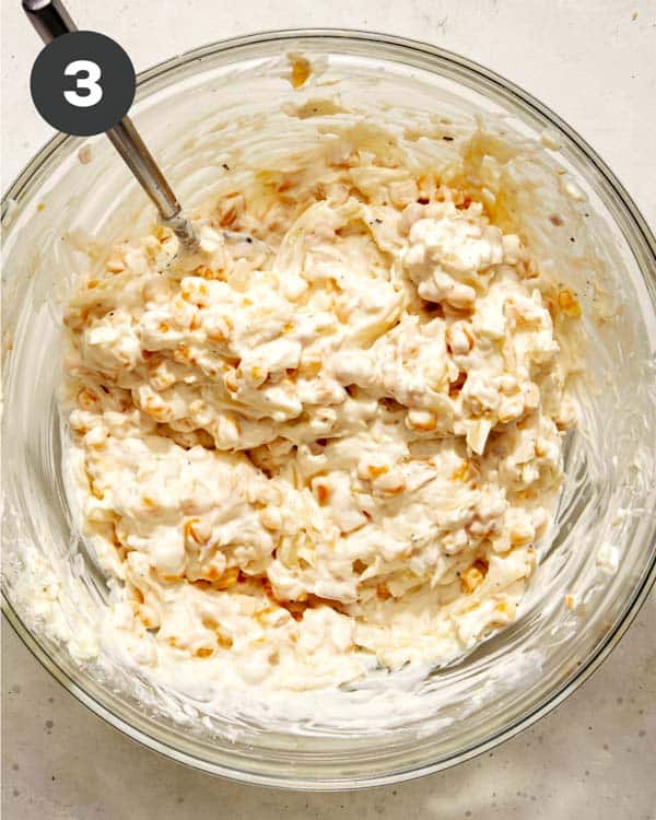 Corn dip mixture in a glass bowl.