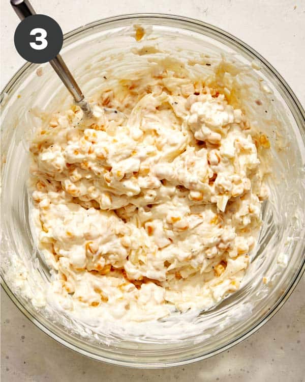 Corn dip mixture in a glass bowl. 