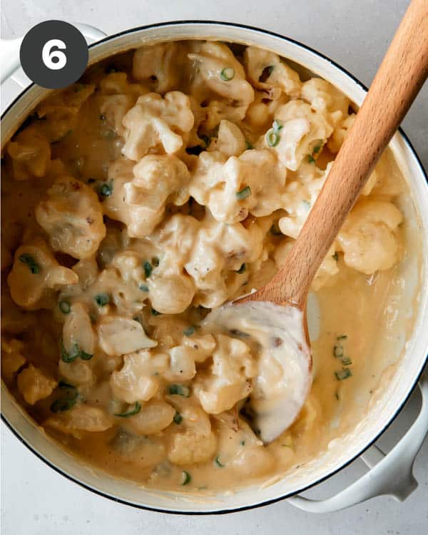 Cauliflower with a cheese sauce in a pot.