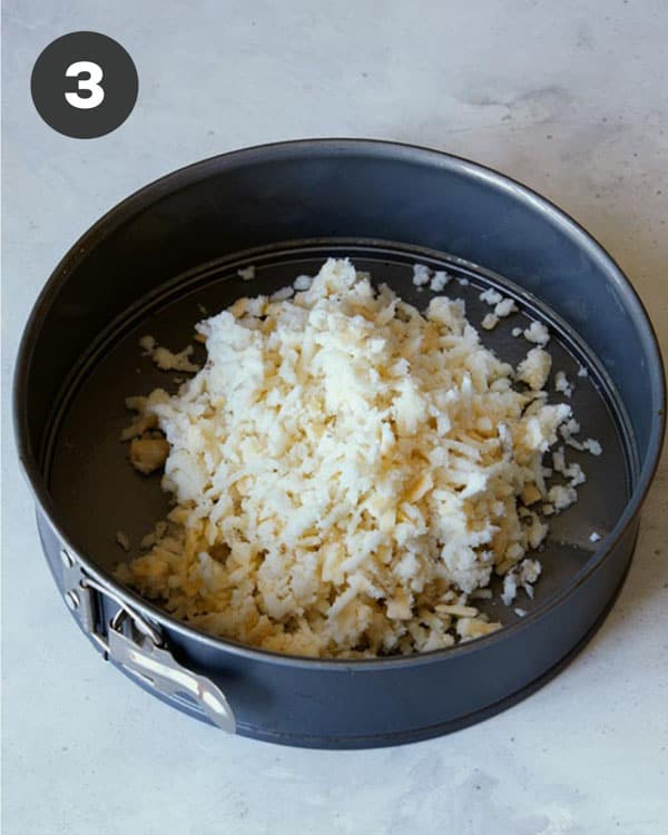 Hash brown crust mixture in a springform pan.