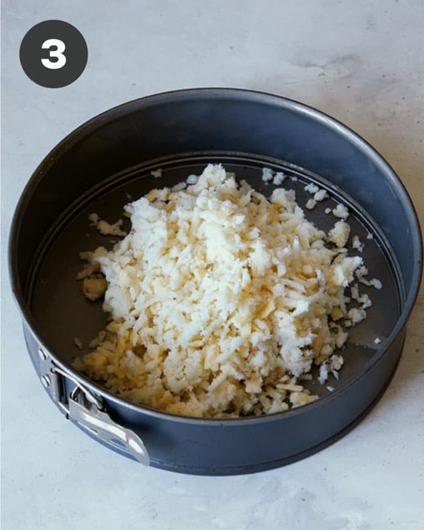 Hash brown crust mixture in a springform pan. 