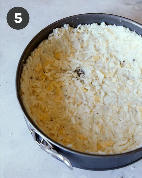 Hash brown crust in a springform pan, close up on the crust.