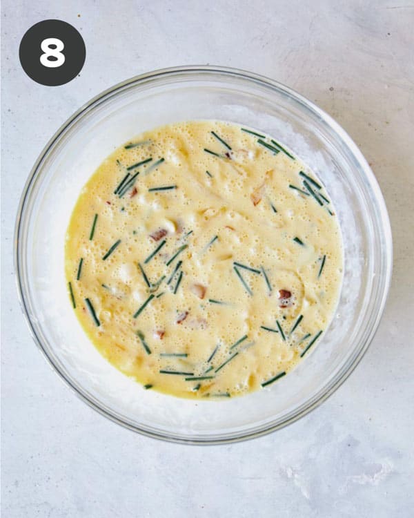 Quiche filling mixture in a mixing bowl combined.
