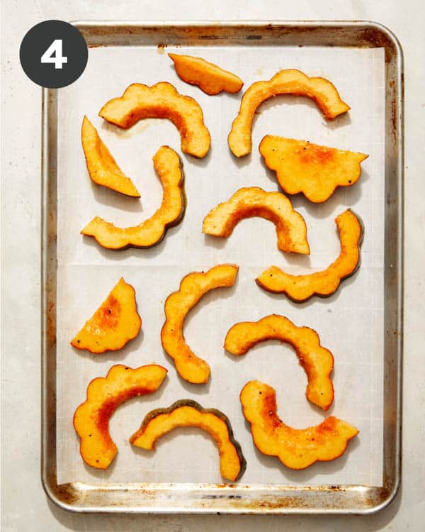 Maple acorn squash on a baking sheet. 