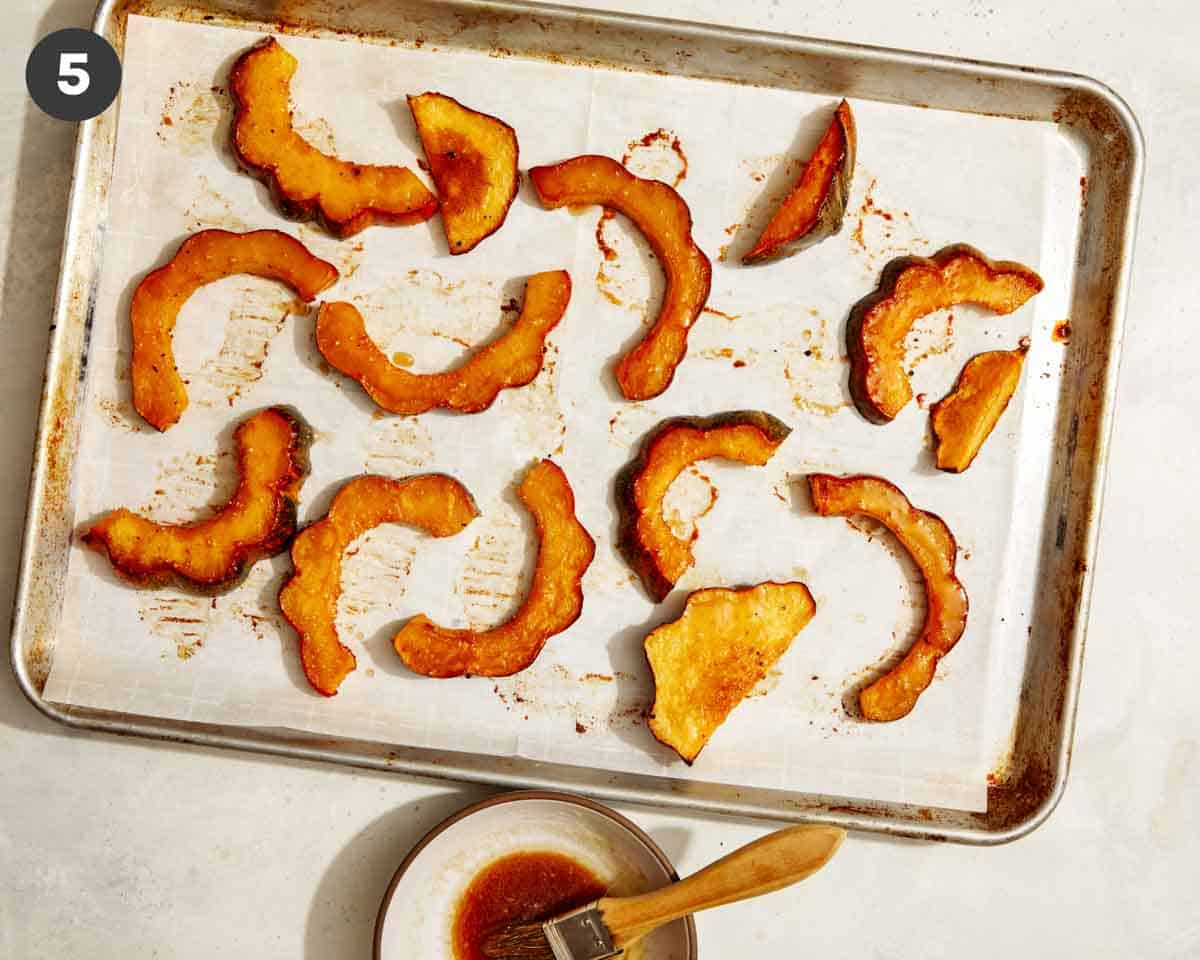 Maple roasted acorn squash on a baking sheet. 