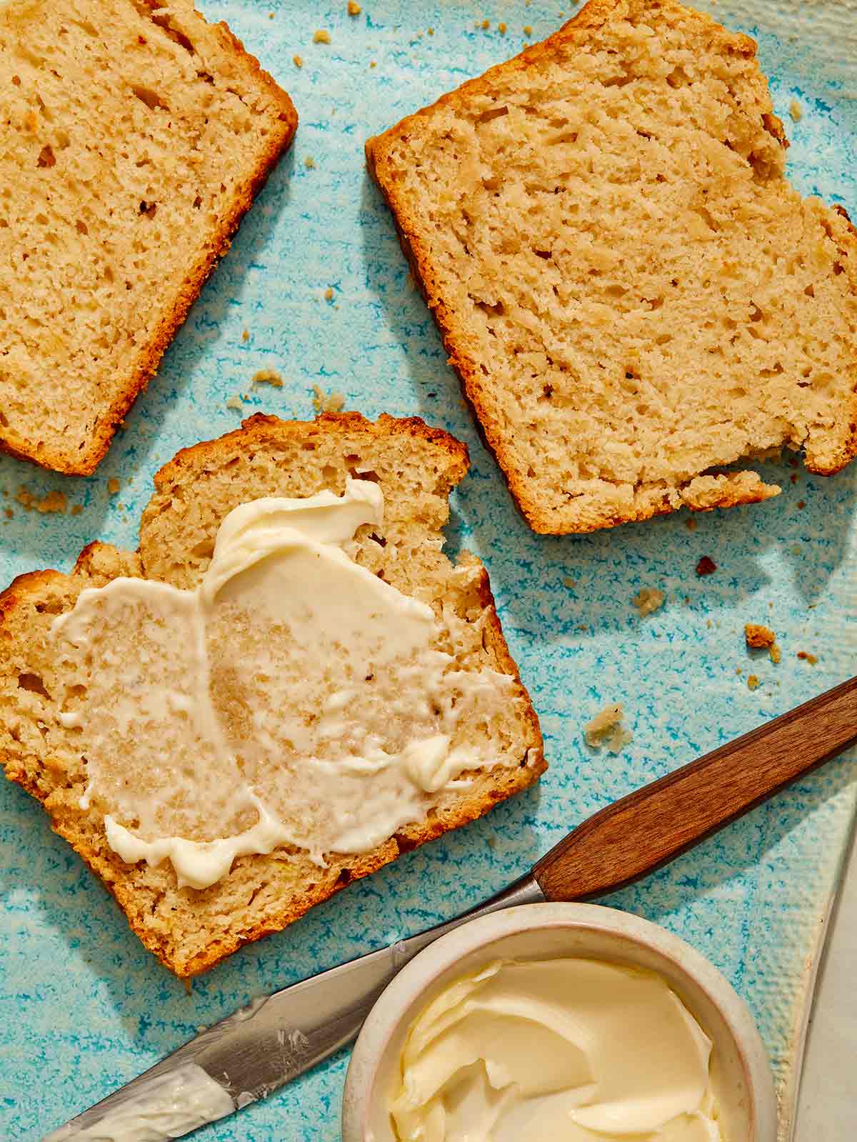 Beer bread on a plate with butter on the slices. 