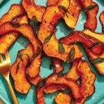 Roasted acorn squash recipe on a plate.