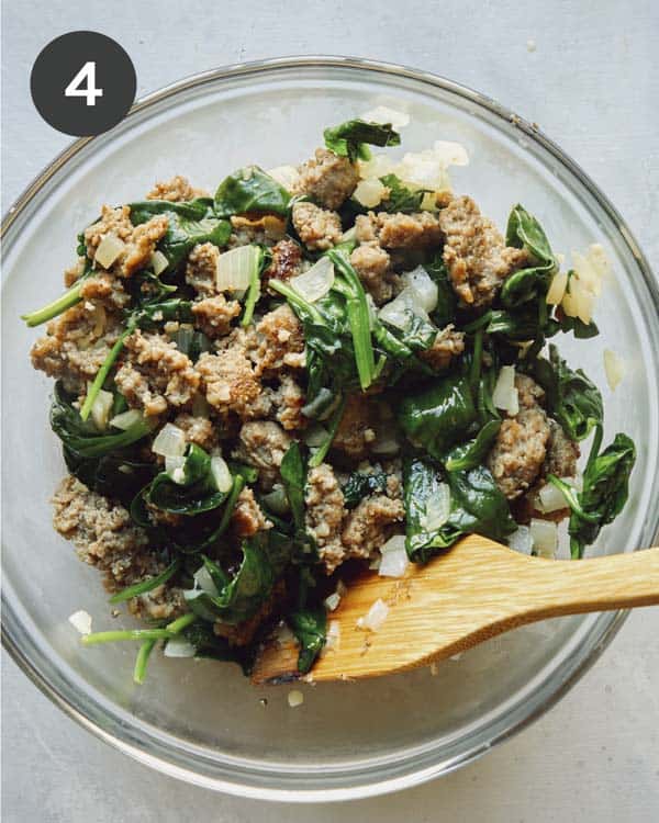 Sausage and spinach and other ingredients for the filling of a strata.