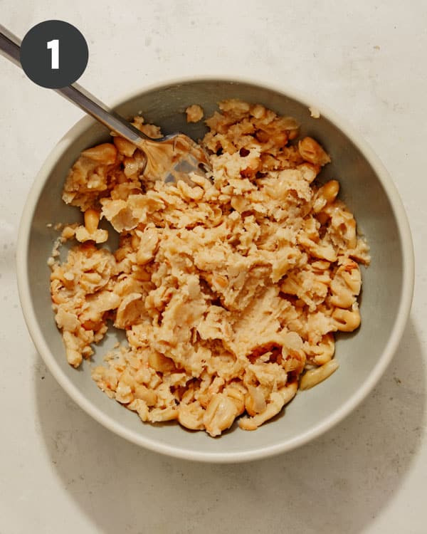 Smashed white beans on a plate. 