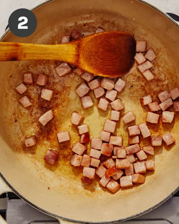 Diced ham cooking in a pot. 