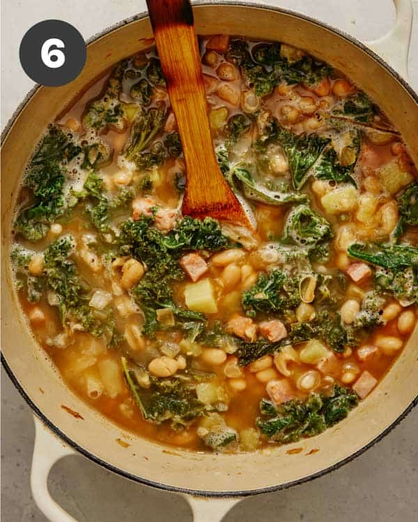 White bean soup in a pot simmering. 