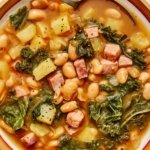 One bowl of white bean and kale soup up close.