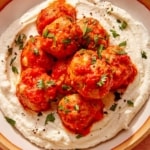 Air fryer turkey meatballs on a plate with bread on the side.