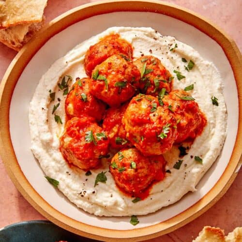 Air fryer turkey meatballs on a plate with bread on the side.