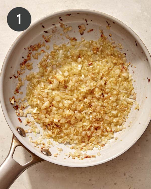 Shallots and garlic cooking in a pan. 