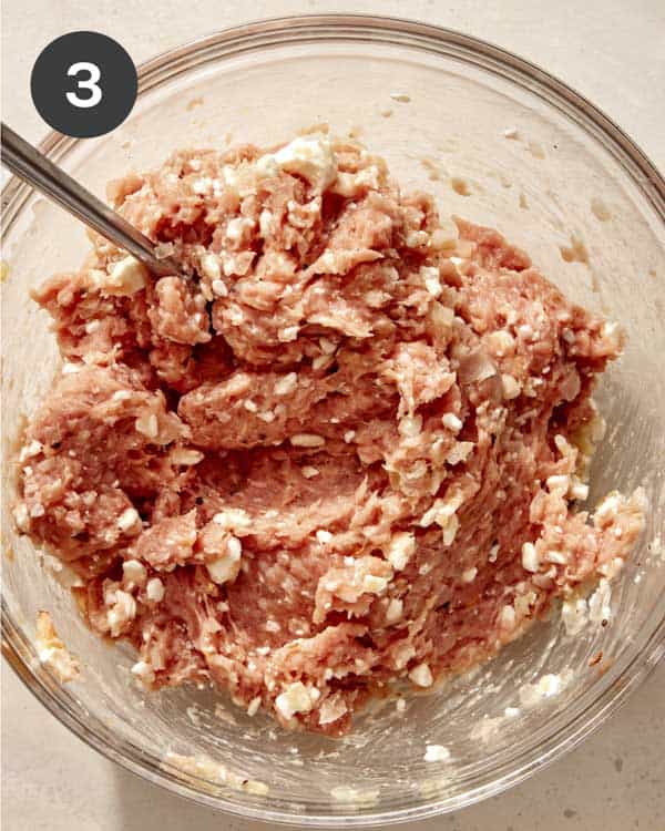 Turkey meatballs in a bowl ready to be rolled up. 