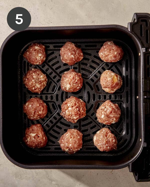 Turkey meatballs being cooked in an air fryer. 